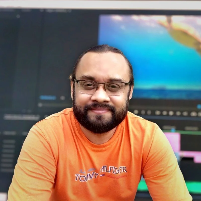 Shaheer Usmani, Professional Video Editor, smiling in front of editing software, praising Prolaxies for their exceptional customer satisfaction.